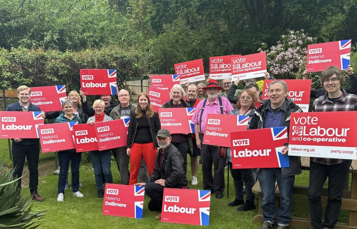 A group of activists holding Labour signs.